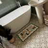 sage green bathroom with vinyl Moroccan tile floor